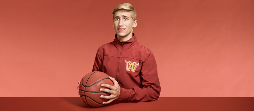 Awkward boy with a basketball