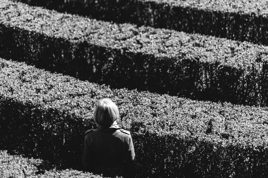 women standing in maze black and white image