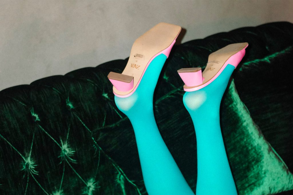women legs with blue panty and pink shoes on green bank