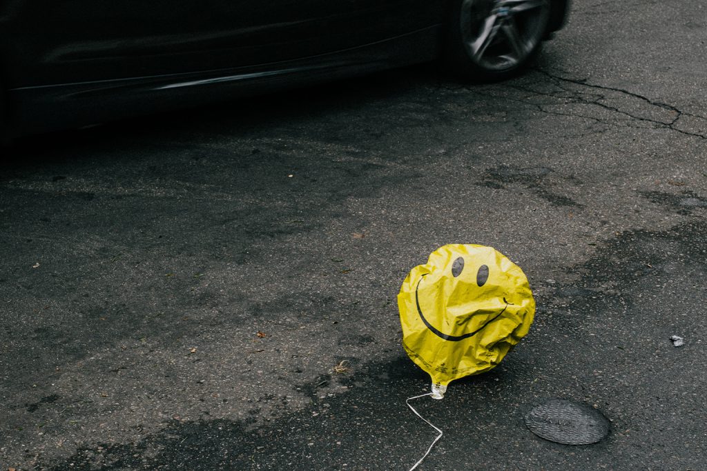 smiley balloon run over by a car