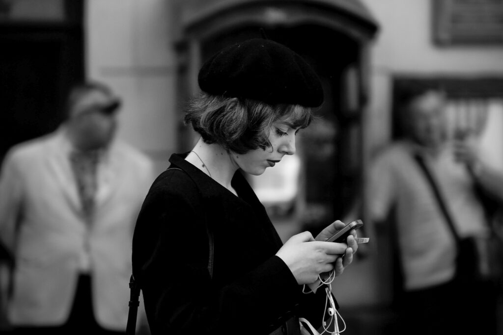 Critical ignorance, women black and white photo scrolling on her phone